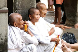 Image of Buddhist nuns sitting in the courtyard of Angkor Wat