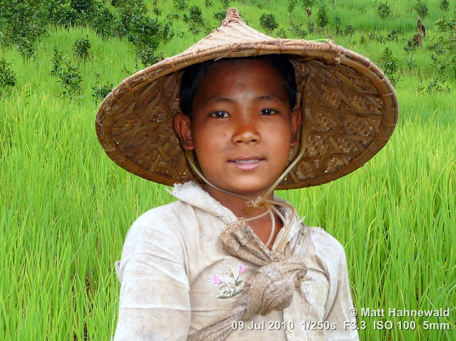 Asian conical hat, conical straw hat, Laotian style conical hat, sedge hat, rice hat, paddy hat, Laotian boy, portrait, headshot, Phongsali