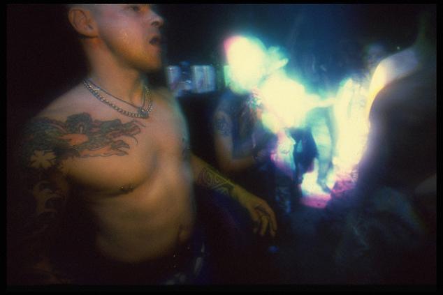 A man with dragon and flower tattoo on his sleeve.