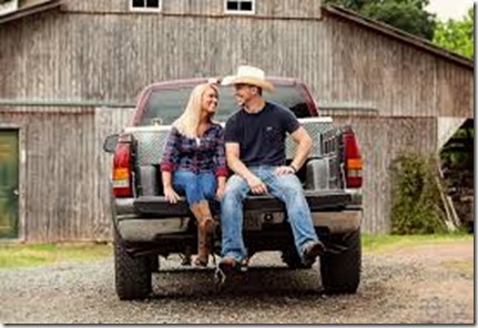 on-back-of-pickup-truck-smiling-at-each-other-cowboy-hat-on