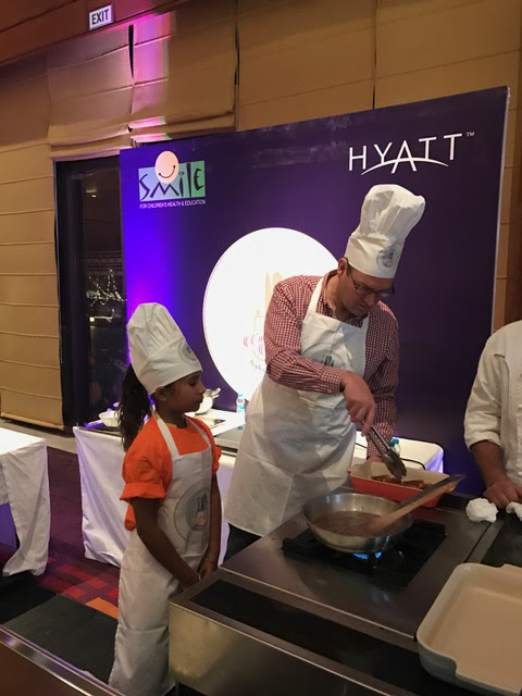 Mr. David Lelliott OBE-British High Commission Chandigarh preparing his dish 'Toad in the Hole with Onion Gravy'