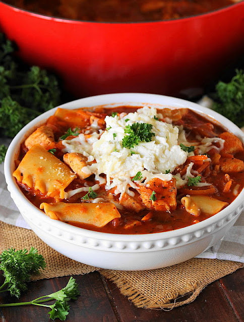 Bowl of Chicken Lasagna Stew Topped with Ricotta and Mozzarella Image