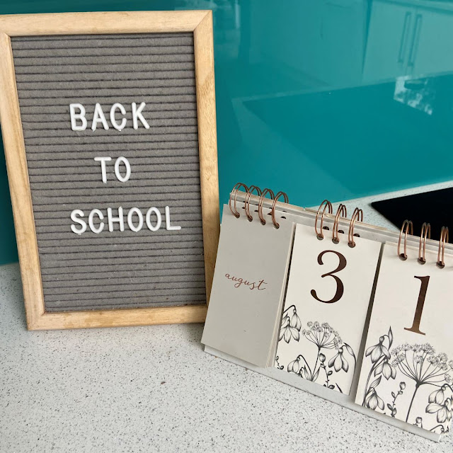 Peg board showing words back to school, next to calendar with August 31st date showing