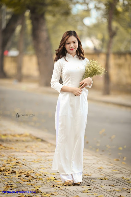 Vietnamese teen girl walking on the street with white ao dai 1