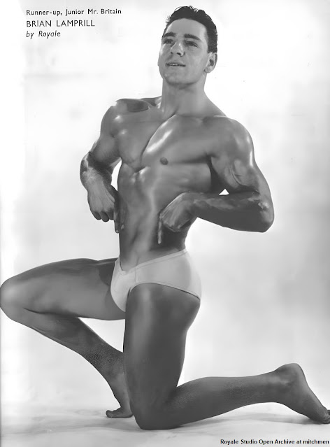 body-builder kneeling, arms flexed on hips