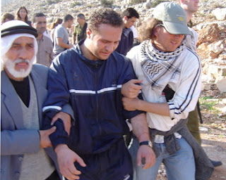 Photo: a keffiyeh-wearing estranged Jew helping "Palestinians" in a demonstration against the IDF