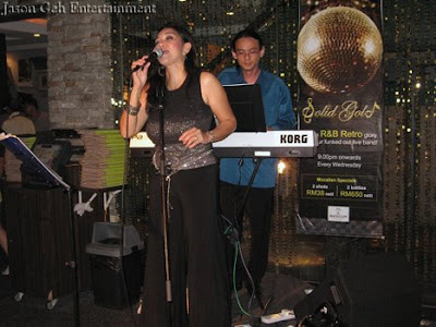 Image of a singer and keyboard player performing live