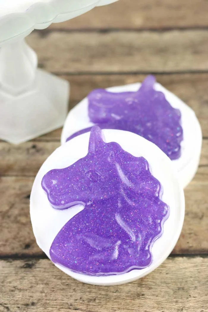 How to make unicorn exfoliating bar soap to remove dead skin. How to make unicorn embeds for a sugar scrub soap recipe. Use white and clear melt and pour soap base for this tutorial. This is a great gift ideas products for friends or teachers. It has additives like oil and sugar for your skin. This fun unicorn designs uses a soap mold.  This simple fun tutorials is great for beginners. DIY recipe with a cute design. #soap #unicorn