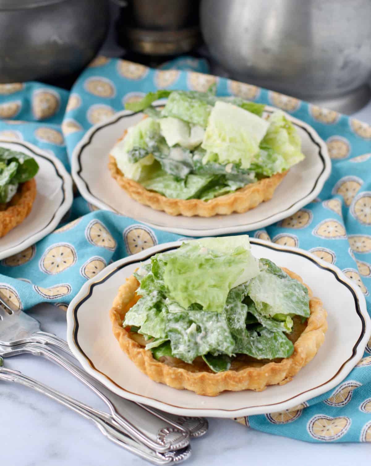 Caesar Tartlets with Sweet Garlic Butter Crusts on plates.