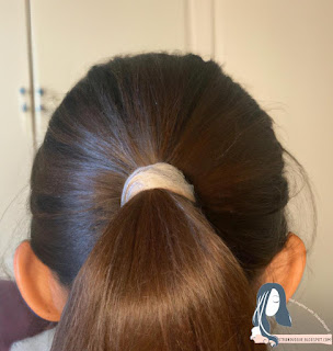Half-Up Ponytail: Pull the top half of your hair back and secure it with a hair tie. 