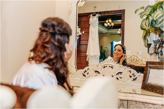 bride putting on earrings