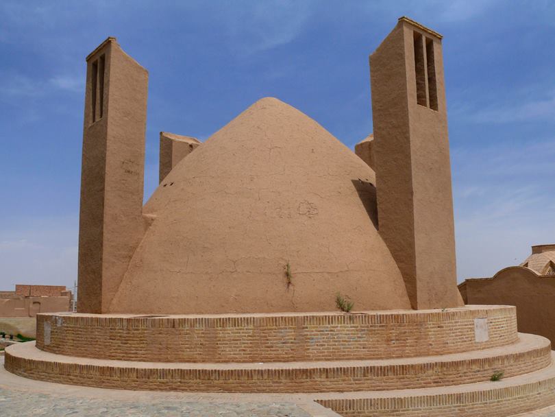 A badgir: typical iranian desert natural cooling system made with mud bricks and Adobe. It uses the air circulation between 2 towers passing through a dome refreshed by the flow of water into an underground channel named Qanat.