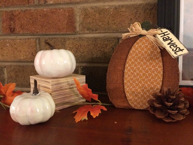 I enjoy mixing neutral shades with the traditional orange and yellows of fall to create a rustic fall mantel and wooden toolbox centerpiece.