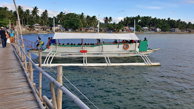 boat being boarded beside bamboo bridge at the port of Matalom, Leyte