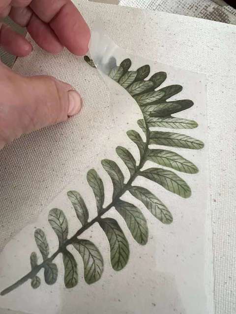 Photo of applying a decor transfer to an art canvas.