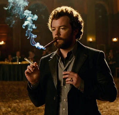 Danny Masterson wearing a red ironing for other Blazer and smoking a cigarette in the cigar