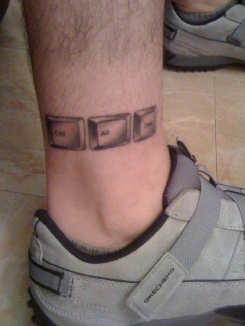 Ctrl, Alt, Del ankle tattoo on guy.