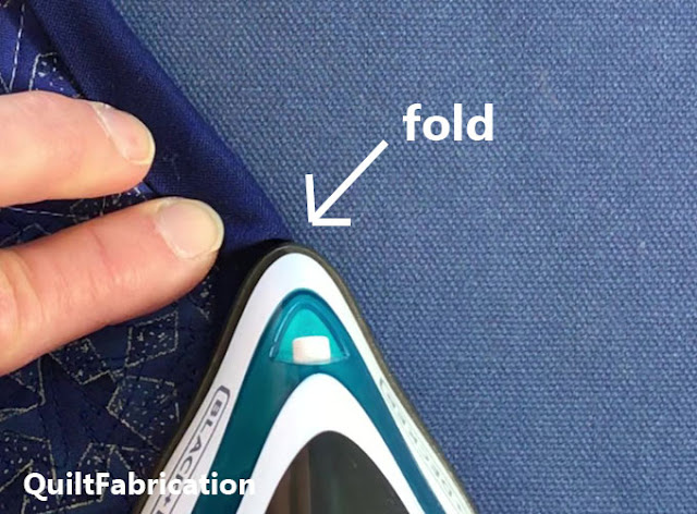 pressing a fold using the iron tip