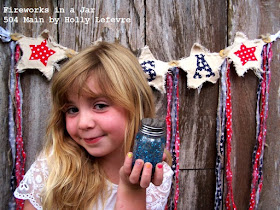 Little gril holding 4th of July craft