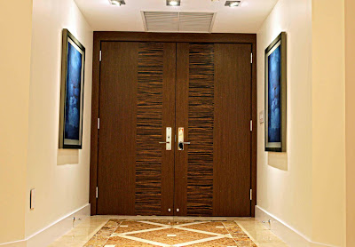 beautiful wood textured door in this lovely foyer with abstract painting