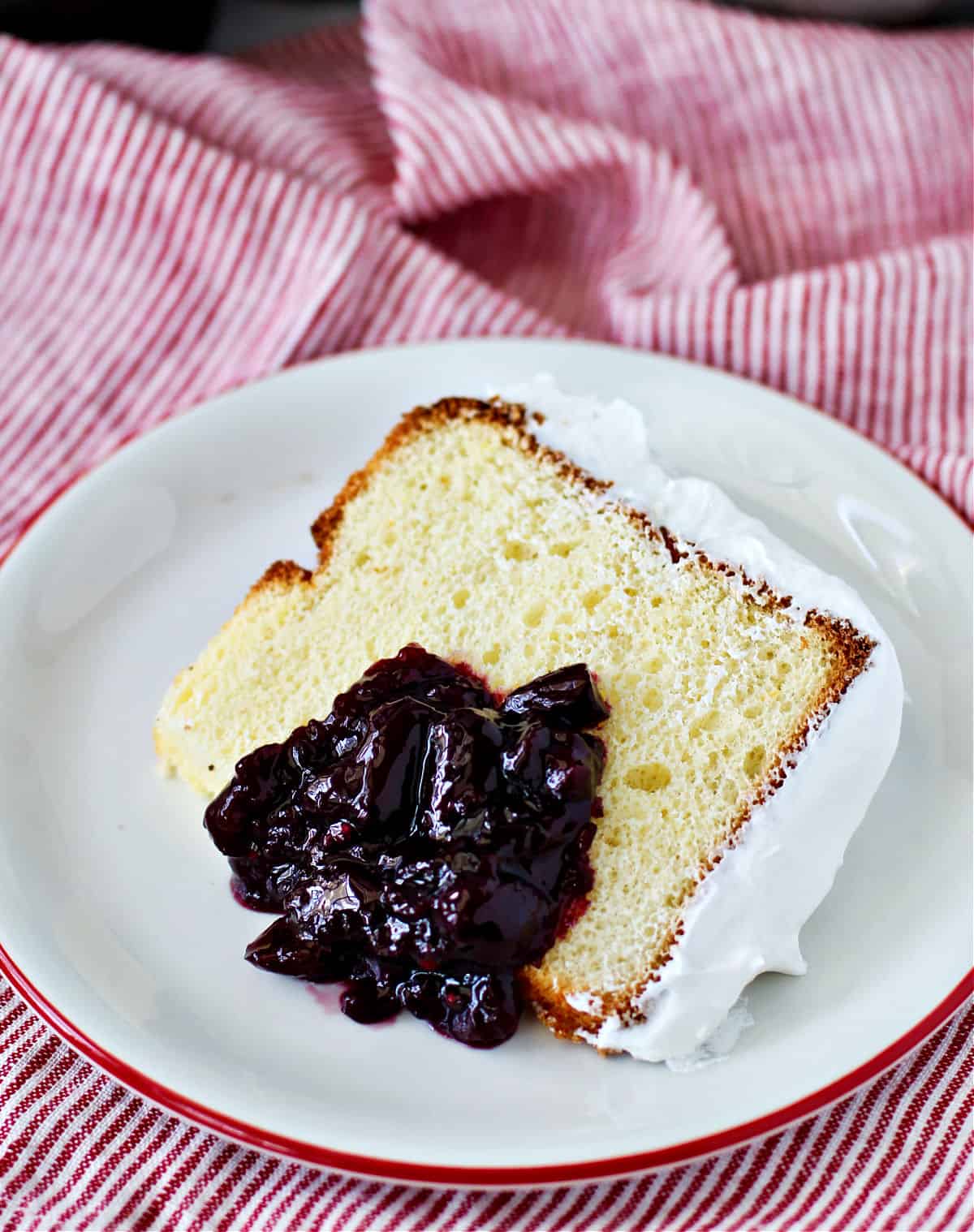 Olive Oil Chiffon Cake with Cherry Sauce on a plate.