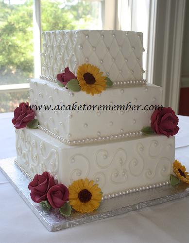 and the square one had gumpaste roses and sunflowers Both cakes had a