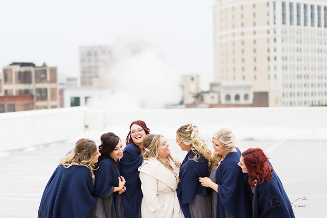 bridesmaids on rooftop at z belt lot laughing