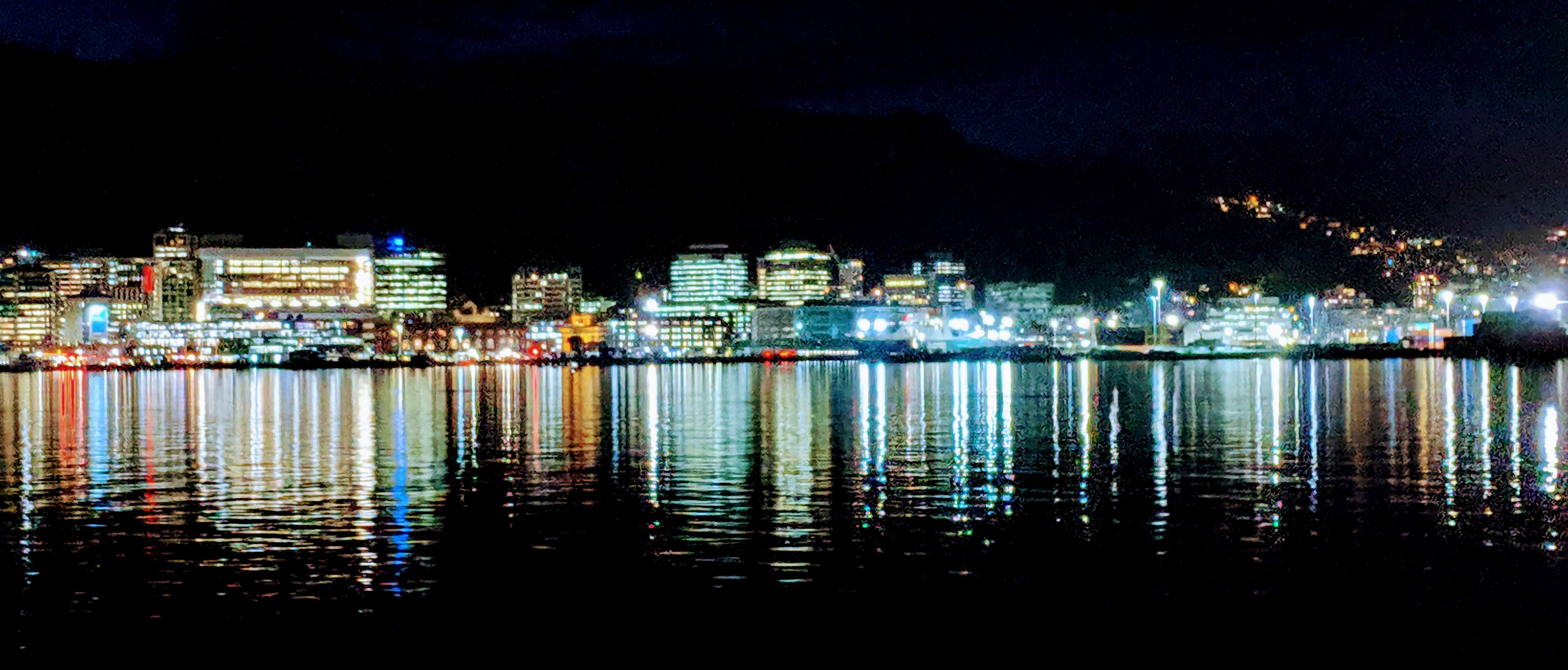 Wellington CBD lights reflected in a calm harbour