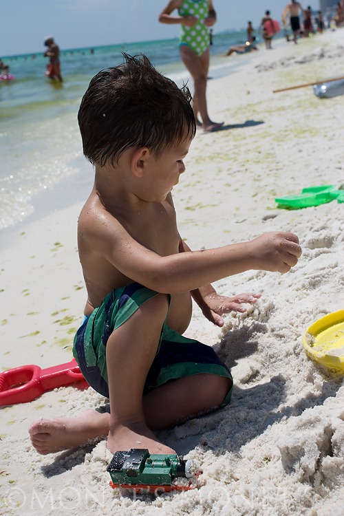 Scott playing in sand at beach blog