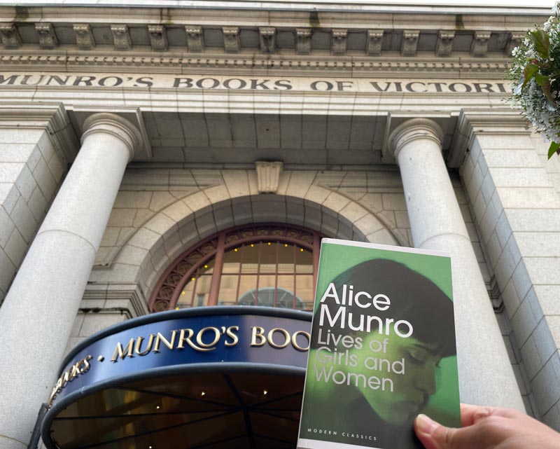 Photograph of Alice Munro's book The Lives of Girls and Women in front of Munro's Books in Victoria, Canada