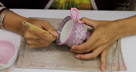 Intricate Benjarong Painting being made on a tea cup at Benjarong village, Thailand