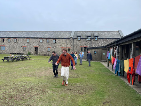 An egg and spoon race in progress with two people dashing.