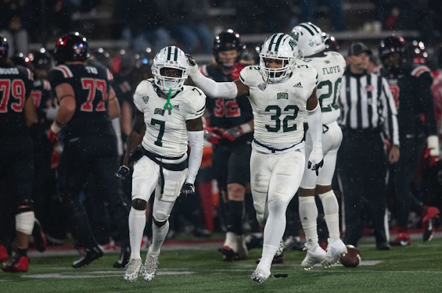 Ohio Bobcats CB Torrie Cox Jr and S Alvin Floyd celebrates along the Ball St Cardinals sideline.