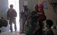 Soldiers provide security during a visit to a medical clinic in the Muthana-Zayuna area of eastern Baghdad.