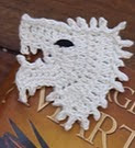 http://www.ravelry.com/patterns/library/game-of-thrones-wolf-applique