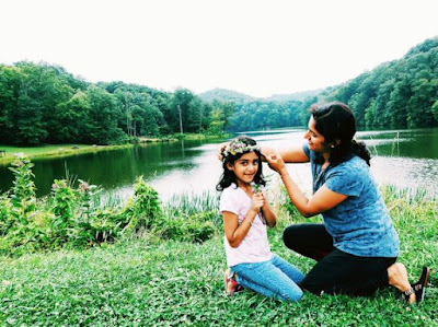 Mom putting on a flower crown on daughter's head