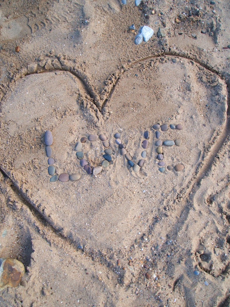 love note written in the sand with pebbles