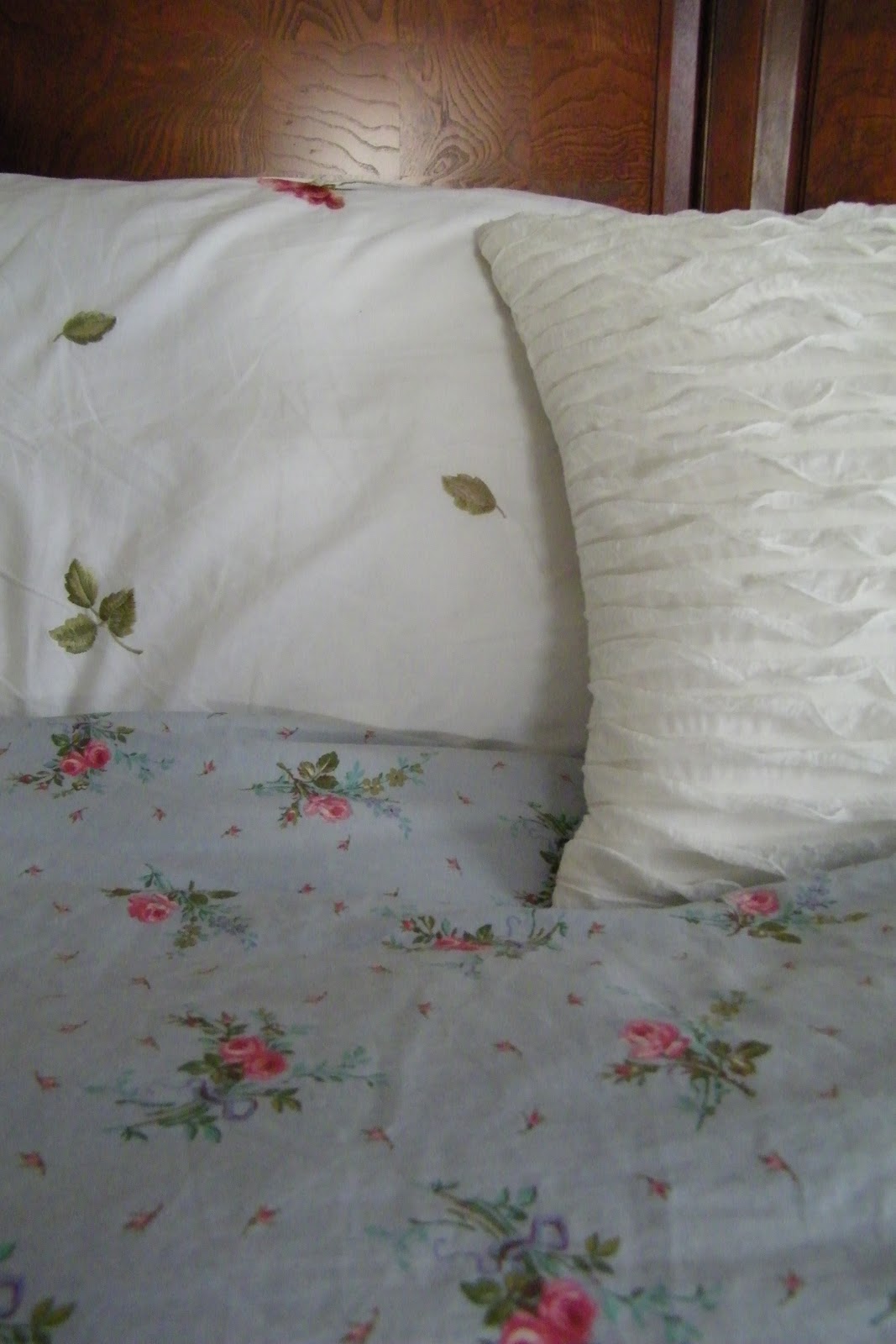 layered over a white Raymond Waites embroidered duvet cover.