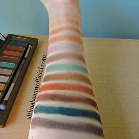 Swatches of Urban Decay Naked Wild West Palette on Ultima Beauty’s arm. Shades: Standoff, Spur, Nudie, Hold 'Em. Cowboy Rick, Laredo, Bud, Rustler, Ghost Town, Whiskey, Tex, Pony Up