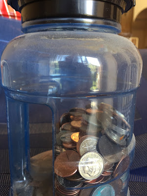 coins in a glass savings jar