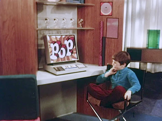 a kid in the "house of tomorrow" in the year 1999, as imagined back in 1967, sits at his desk and ponders a computer screen that just says "pop"