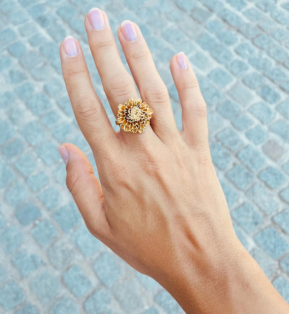 models hand showing a gold vermeil, hand-crafted, flower statement ring