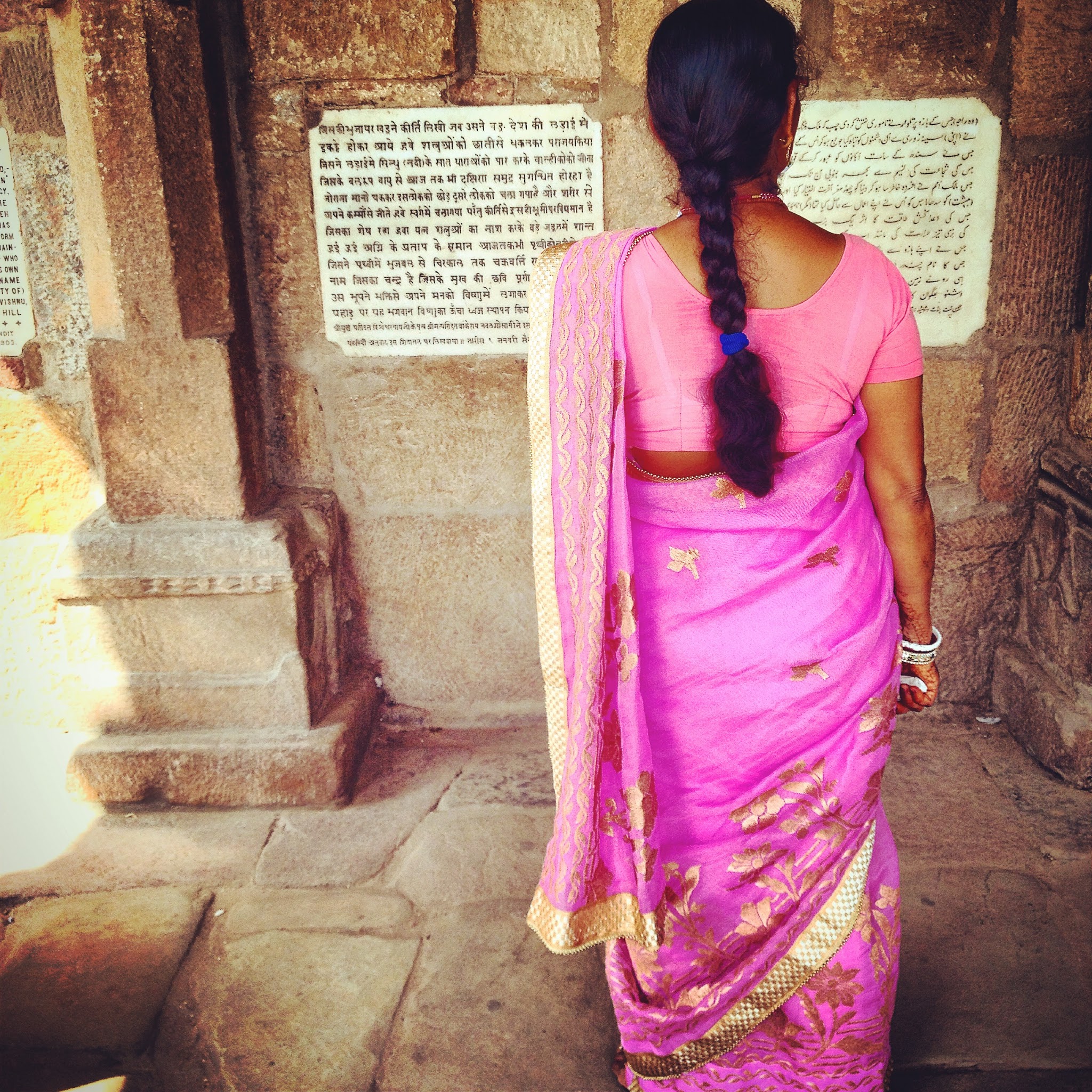 An indian women wearing a pink and gold sari in delhi india