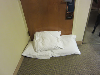 Photo of the three pillows stuffed at the foot of the door. 