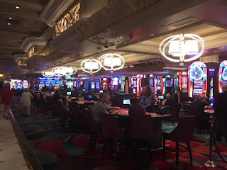 players at brightly lit gambling tables
