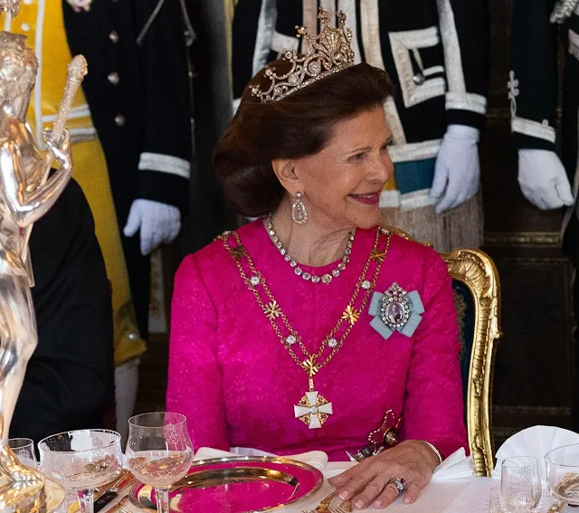 Queen Silvia wore a Padme pink gown by Georg et Arend. Princess Victoria wore a feather cape gown by Toteme