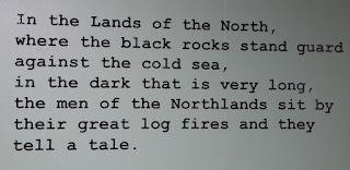 Typed text: "In the Lands of the North, where the black rocks stand guard against the cold sea, in the dark that is very long, the men of the Northlands sit by their great log fires and they tell a tale."