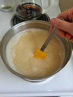 Stirring mixture in a pot on the stove.