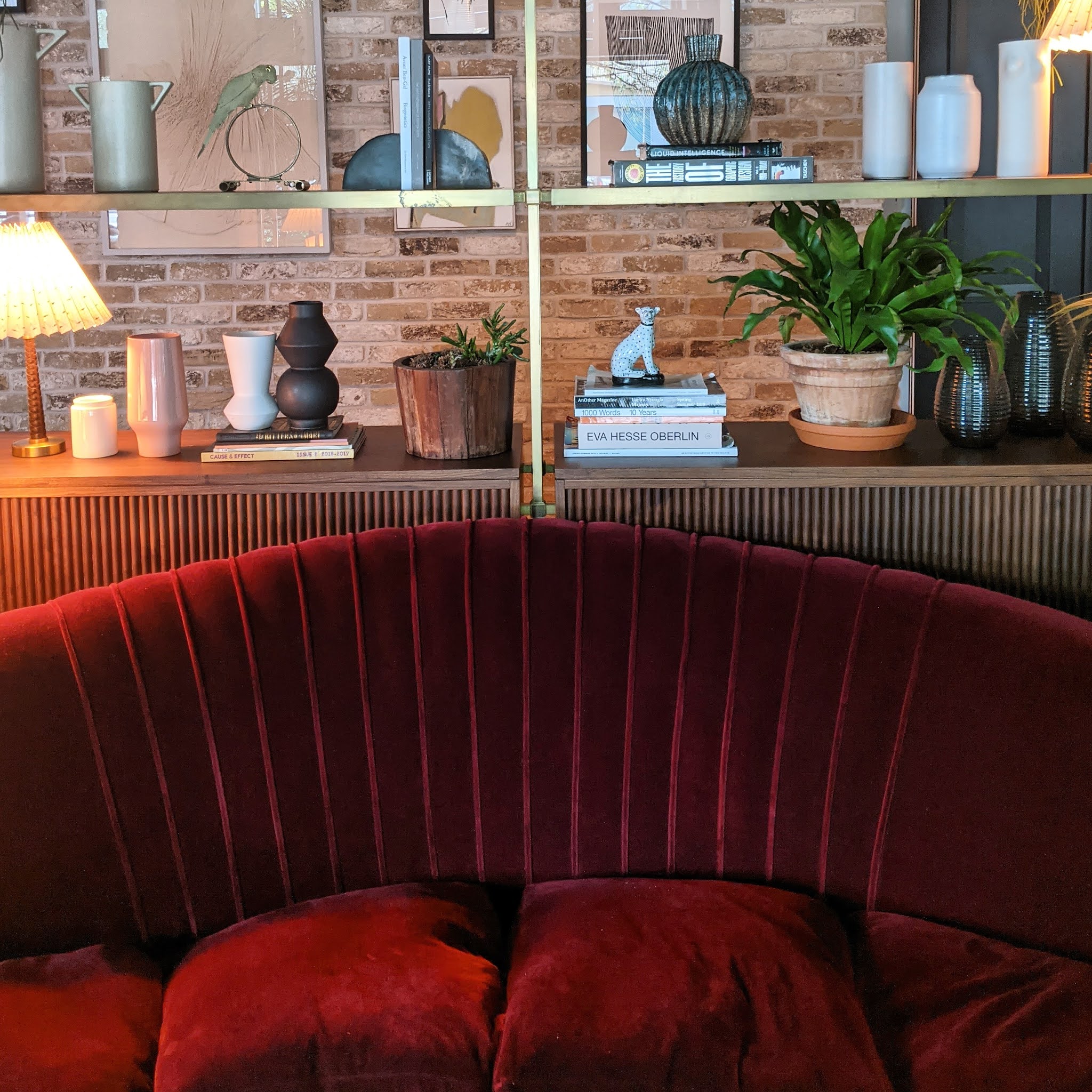 red sofa and bookshelves in the lobby of the hoxton southwark