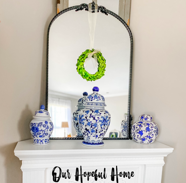 black metal arched mirror with chinoiserie ginger jars